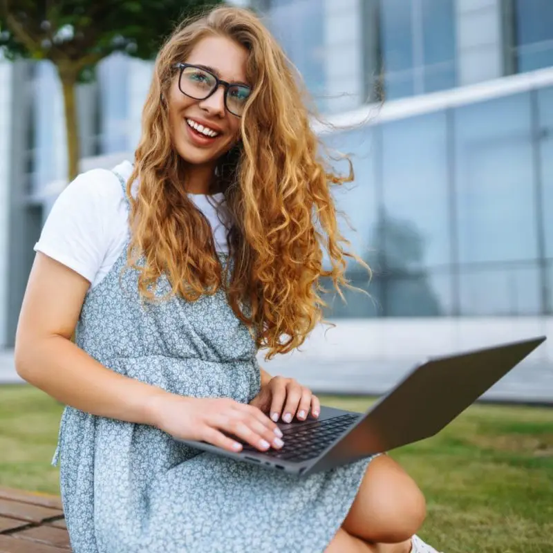 young-woman-with-laptop-outdoor-education-online-freelancer-business-shopping-blogging