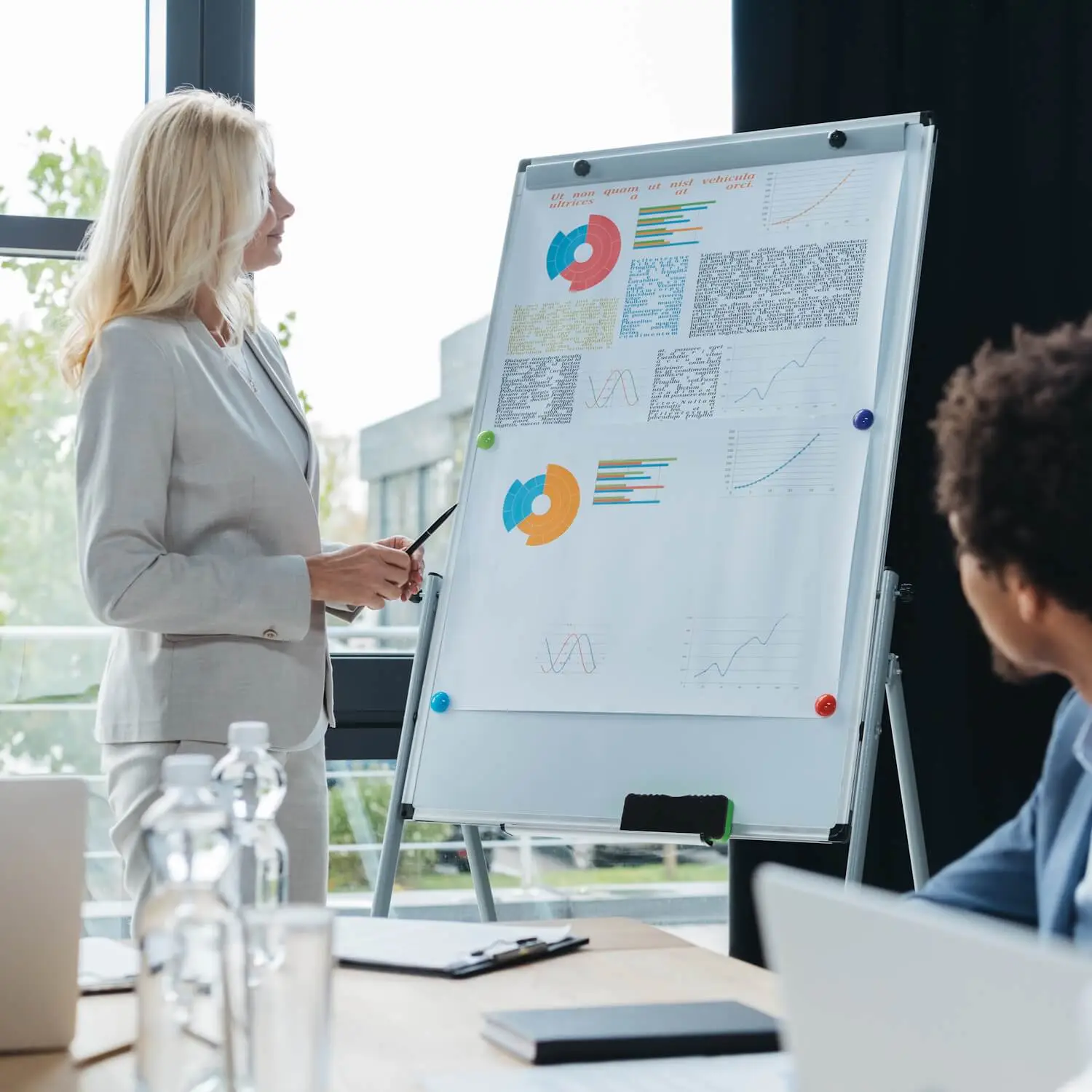 Woman presenting at meeting, showing results of boosted productivity after leveraging Words by a Pro services.