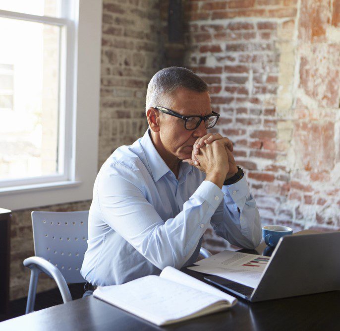 mature-businessman-with-hands-on-chin